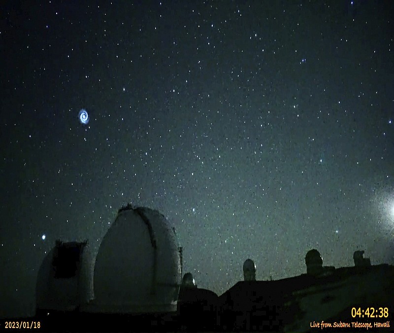 This image taken from video provided by the NAOJ & Asahi Shimbun, shows spiral swirling through the night sky from Mauna Kea, Hawaii's tallest mountain. Researchers believe it shows the after effects of a SpaceX rocket launch when the company's Falcon 9 rocket sent a GPS satellite into orbit. The images were captured on Jan. 18, 2023, by a camera at the summit of Mauna Kea outside the National Astronomical Observatory of Japan's Subaru telescope. (NAOJ & Asahi Shimbun via AP)