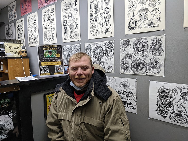 Ryan Pivoney/News Tribune
Bryce Hickman takes a break from greeting supporters outside The Nook tattoo parlor Sunday. The Nook hosted area tattoo artists for a flash sale to benefit Hickman, who was diagnosed with stage four kidney cancer earlier this month.