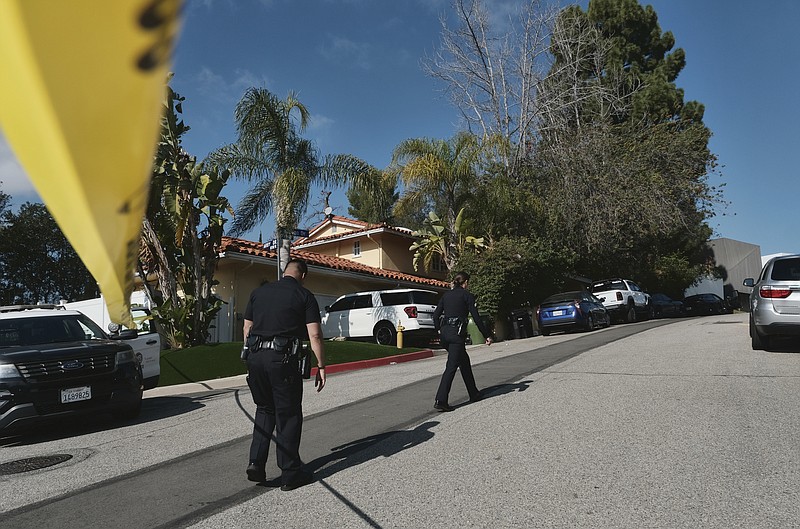 FILE - Police block the street to a house where three people were killed and four others wounded in a shooing at a short-term rental home in an upscale Los Angeles neighborhood on Saturday Jan. 28, 2023. The shooting occurred about 2:30 a.m. in the Beverly Crest neighborhood. (AP Photo/Richard Vogel, File)