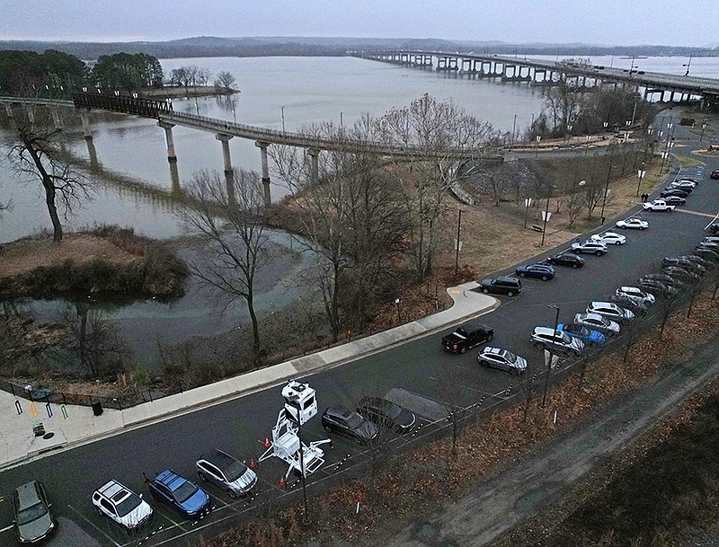 The parking lot near the Two Rivers Park Bridge, seen here in this Saturday, Jan. 28, 2023 aerial photo, has been the site of an increasing frequency of vehicle break-ins in recent years. (Arkansas Democrat-Gazette/Colin Murphey)