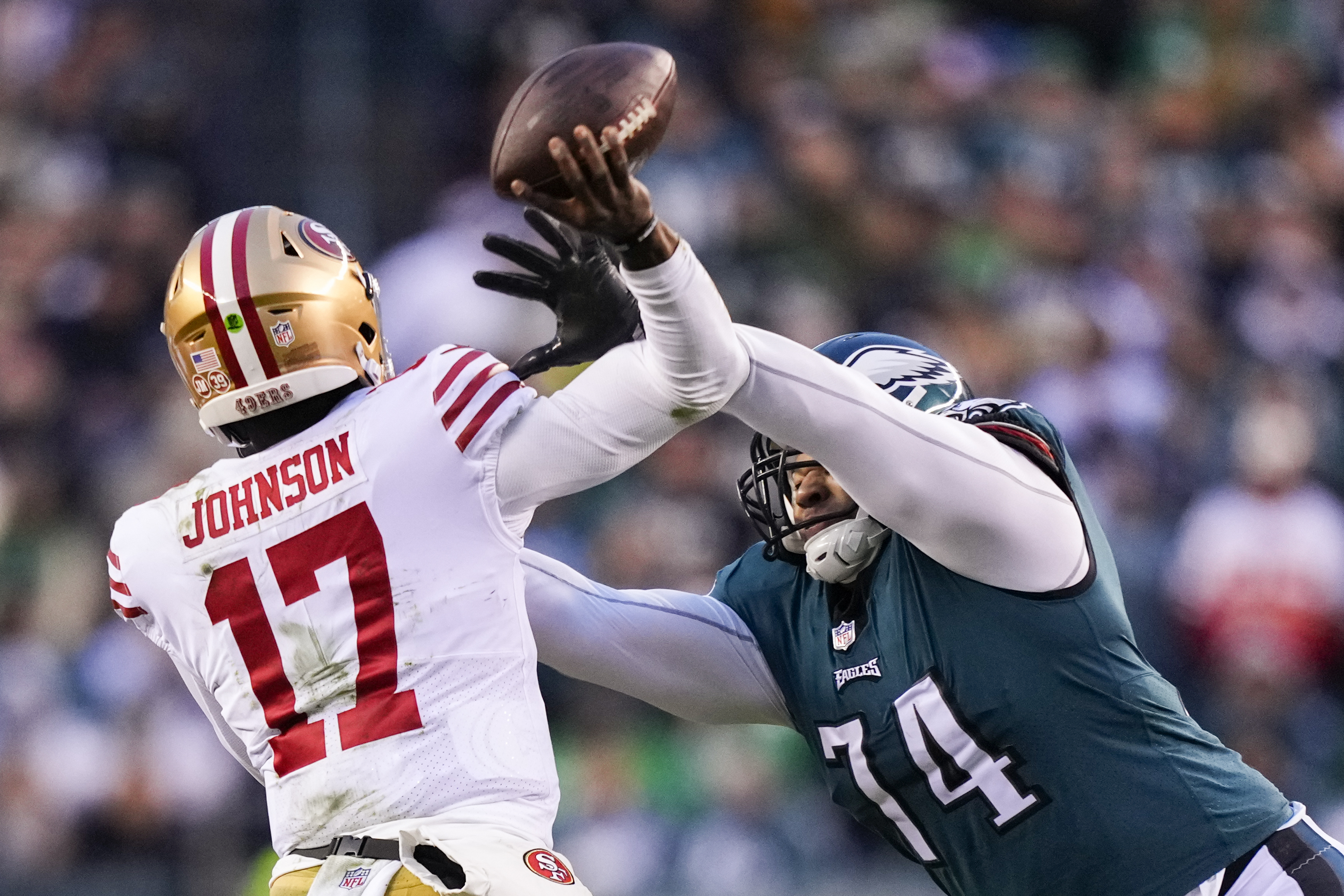 Philadelphia Eagles' Fletcher Cox, left, and Ndamukong Suh walk to