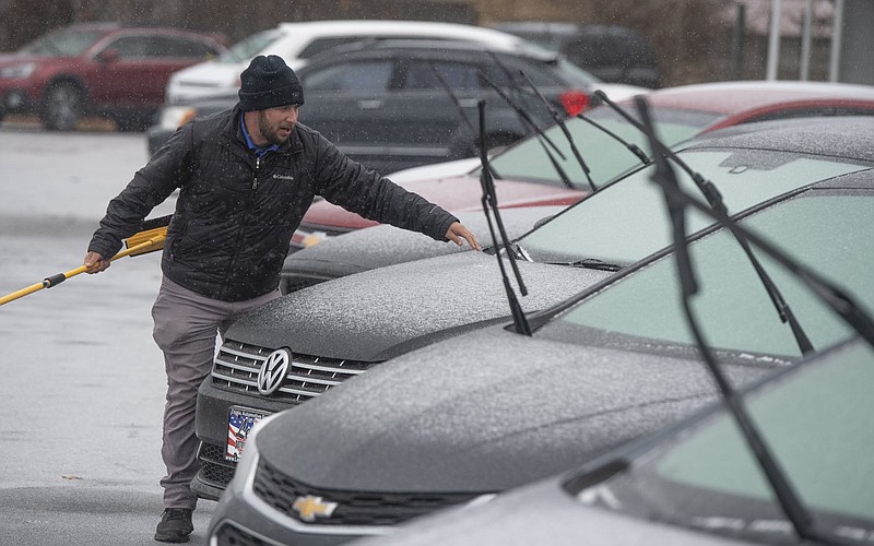 Derrick Porter, salesman at Lewis Automotive in Farmington, raises windshield wipers on cars Monday Jan. 30, 2023 as freezing rain begins to fall. The National Weather Service is calling for more winter weather this week with a possibility of snow and sleet Tuesday.  Visit nwaonline.com/photo for today's photo gallery.   (NWA Democrat-Gazette/J.T. Wampler)