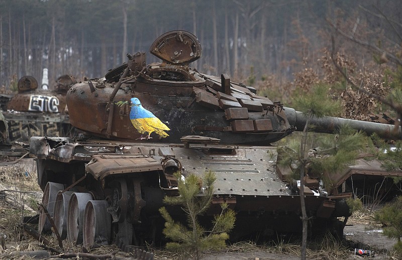 A destroyed Russian tank with an artwork depicting a dove with an olive branch by famous street artist TvBoy, amid Russia's attack on Ukraine, in the village of Dmytrivka, outside Kyiv, Ukraine Monday, Jan. 30, 2023. (AP Photo/Efrem Lukatsky)