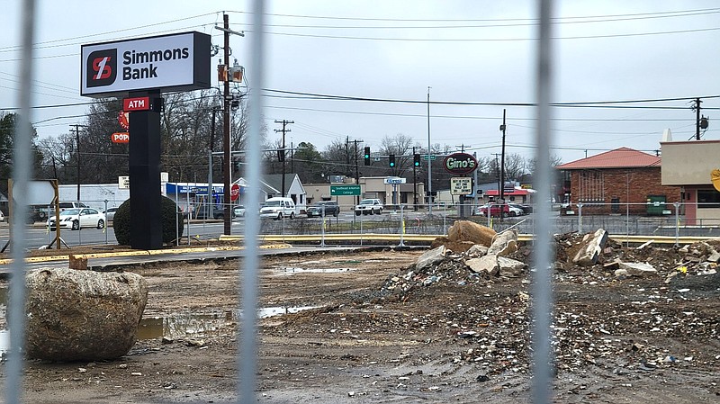 The Simmons Bank branch at Jefferson Square, 2801 S. Olive St., is demolished and pictured behind a protective fence Sunday. (Pine Bluff Commercial/I.C. Murrell)