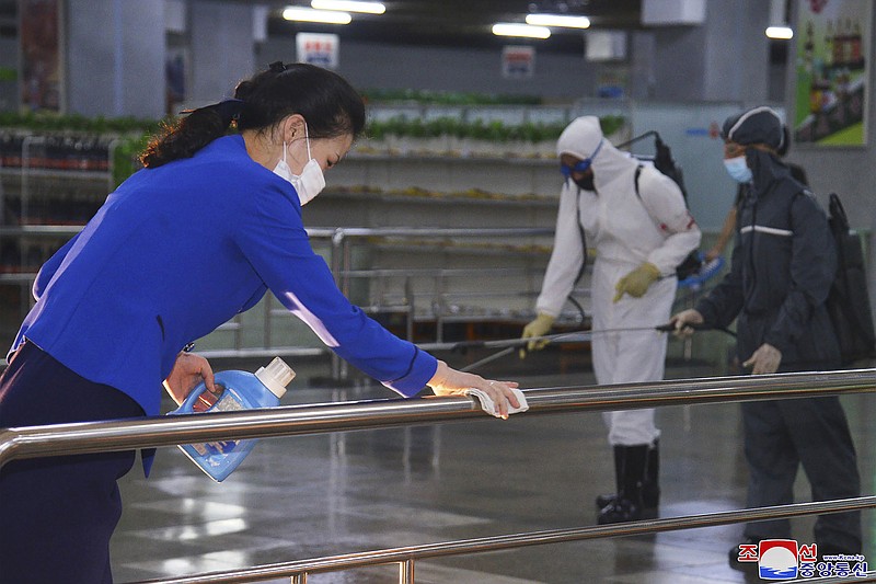 FILE - In this photo published on June 28, 2022 by the North Korean government, North Korean employees disinfect a facility at an underground store in Pyongyang, North Korea. Independent journalists were not given access to cover the event depicted in this image distributed by the North Korean government. The content of this image is as provided and cannot be independently verified. Korean language watermark on image as provided by source reads: "KCNA" which is the abbreviation for Korean Central News Agency. (Korean Central News Agency/Korea News Service via AP, File)