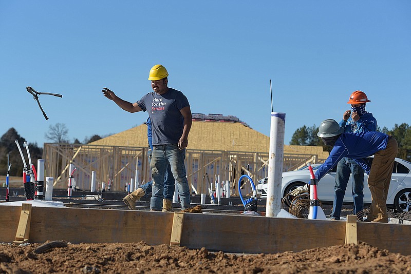 Construction workers build a house in February 2022 at Regency Place, an affordable housing addition in Chaffee Crossing n Fort Smith. Visit nwaonline.com for today's photo gallery.
(File Photo/River Valley Democrat-Gazette/Hank Layton)