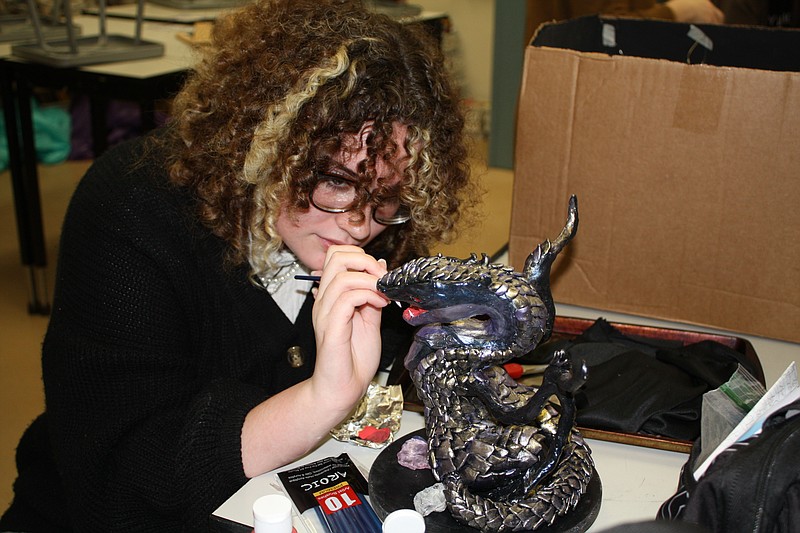 Texas High School Student Jade Muniz pays close attention to her handmade dragon sculpture that she made in art teacher Shea Phillip's class. Staff photo by Mallory Wyatt