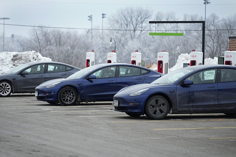 Tesla vehicles charge at a charging station, Monday, Jan. 23, 2023, in Robbinsdale, Minn. (AP Photo/Abbie Parr)