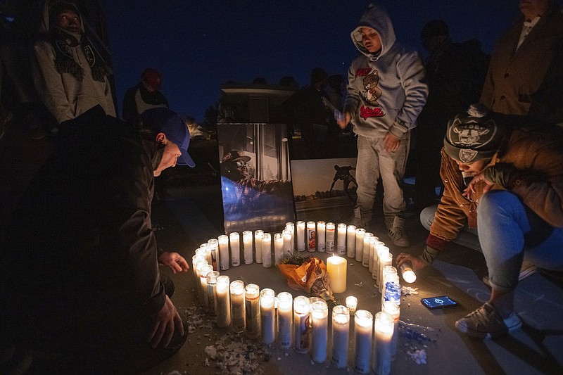 CORRECTS NAME TO SOQUOIA -Soquoia Green, a cousin of Tyre Nichols, lights candles with family and friends during a vigil for him late Monday, Jan. 30, 2023, at Regency Community Skate Park in Natomas, where Tyree used to skateboard when he lived in Sacramento, Calif. Nichols, who moved to Tennessee in 2020, was fatally beaten by Memphis police earlier this month. (Paul Kitagaki Jr./The Sacramento Bee via AP)