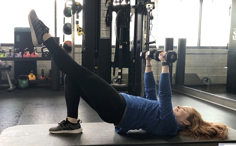 Sarah Martinez, fitness director of North Little Rock Athletic Club, demonstrates step 6 of the Isometric Chest Press With Hip Raise exercise for Matt Parrott's Master Class. (Arkansas Democrat-Gazette/Celia Storey 1/17/23)