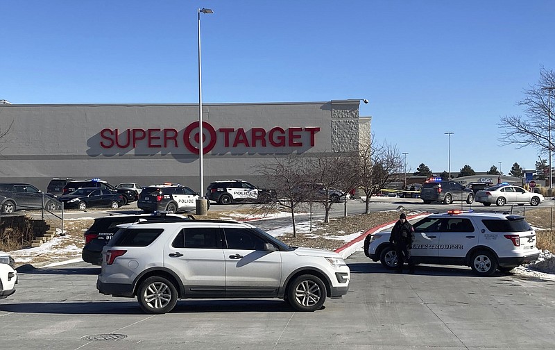 Omaha, Neb., police officers gather outside a Target store in Omaha on Tuesday, Jan. 31, 2023. They were investigating reports of a shooting at the store Tuesday. Police spokesman Officer Chris Gordon said the store in west Omaha was locked down about noon Tuesday after reports of shots being fired. The department said on its Twitter site that authorities were clearing the store, and that the scene had been secured. (AP Photo/Josh Funk)