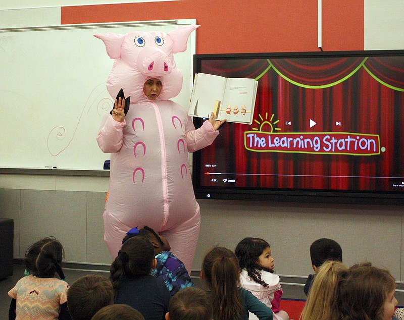 Pleasant Grove Independent School District librarian Jenifer Thomas dresses in a pig costume to read to pre-kindergarteners during World Read Aloud Day on Wednesday, Feb. 1, 2023, at Margaret Fischer Davis Elementary in Texarkana, Texas. Thomas selected picture book "Too Many Pigs and One Big Bad Wolf: A Counting Story." District employees read to students at each school to encourage literacy. (Staff photo by Mallory Wyatt)