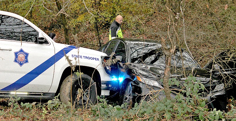 An Arkansas State Police vehicle rests against the passenger side of a vehicle after executing a PIT maneuver on East Grand Avenue near Westinghouse Terrace on Nov. 29, 2022. - File photo by James Leigh of The Sentinel-Record