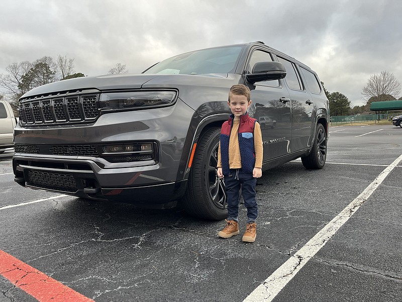 Jackson Bright, son of James Bright who reviews the Jeep Grand Wagoneer, stands next to the vehicle before returning it to the maker. (Photo by James Bright)