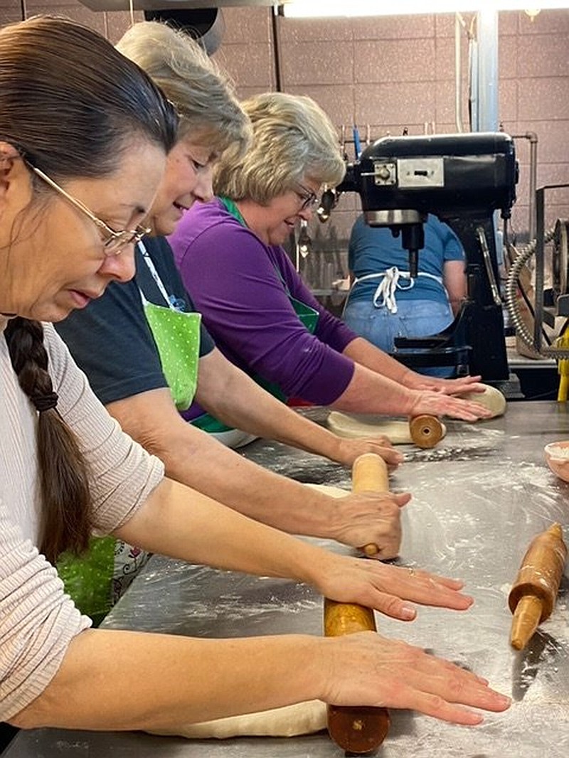 Ann Scherm, Beth White, and Maria Vallejo roll bread dough for the annual spaghetti dinner at Our Lady of the Lake Catholic Church at Lake Village. (Special to The Commercial)