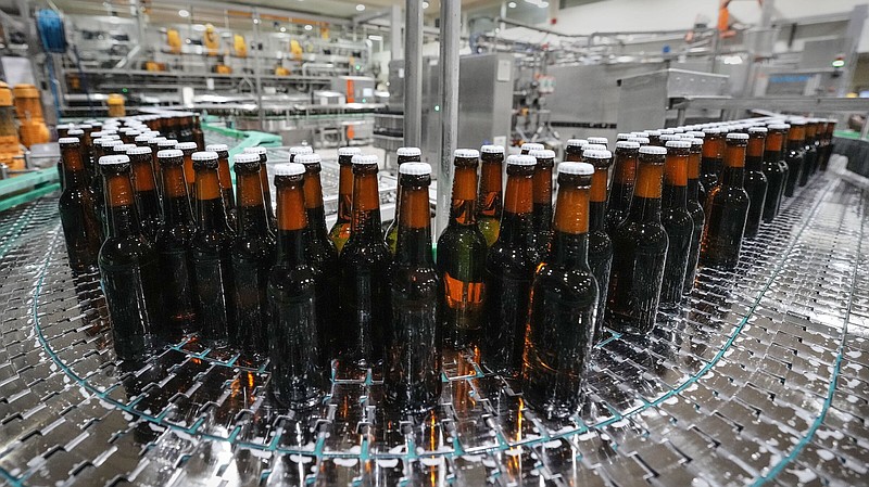 FILE -- Beer bottles are filled at the Veltins beer brewery in Meschede, Germany, Wednesday, Aug. 24, 2022. The Federal Statistical Office said on Wednesday that German-based breweries and distributors sold about 8.8 billion liters (2.3 billion gallons) of beer last year, a 2.7% increase compared with 2021.  (AP Photo/Martin Meissner, file)
