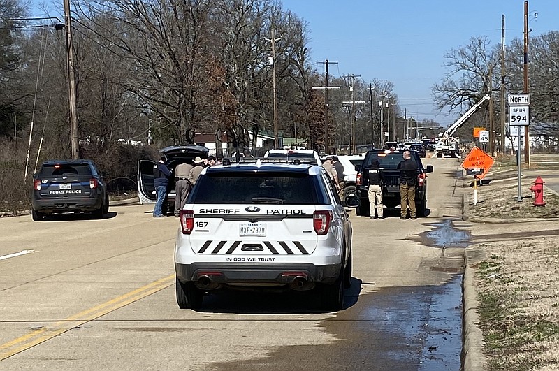 Law enforcement cordon off Spur 594 on Friday, Feb. 3, 2023, in Hooks, Texas, as officers negotiate with a man who has barricaded himself in his house. The situation developed after the unidentified man threatened SWEPCO workers. (Staff photo by Stevon Gamble)