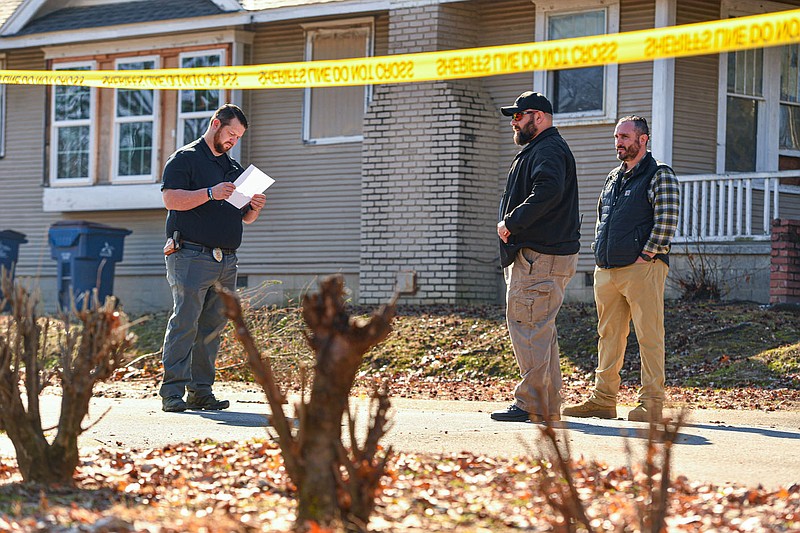 Investigators with the Fort Smith Police Department work, Friday, Feb. 3, 2023, at the site of a shooting death at a residence on the corner of Grand Avenue and 18th Street in Fort Smith. According to Aric Mitchell, FSPD public information officer, the homeowner, a 58-year-old male, contacted police around 9:45 a.m. to report the shooting of a 29-year-old knife-wielding man who allegedly broke into the residence. The suspected intruder died on scene from a gunshot wound to the abdomen. The homeowner was taken to a hospital at his request to treat non-life-threatening injuries. Visit nwaonline.com/photo for today's photo gallery.
(NWA Democrat-Gazette/Hank Layton)