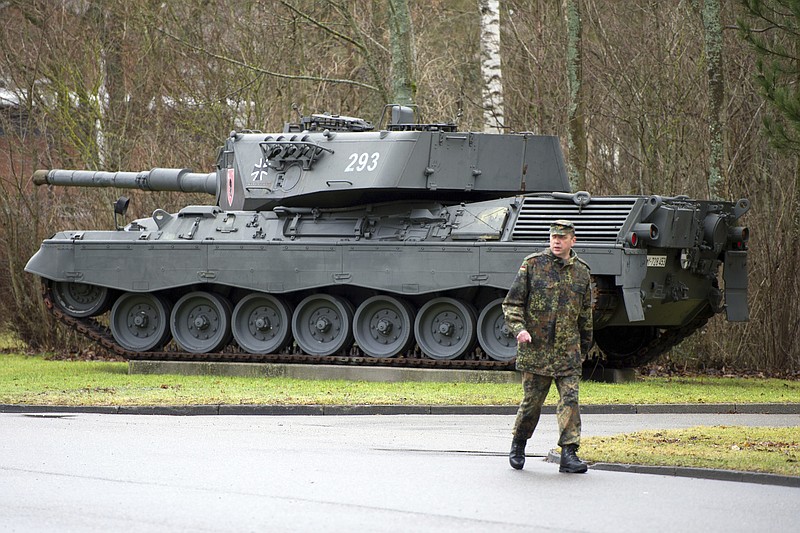 FILE -  A soldier walks past a Leopard 1 A4 main battle tank on display at the Graf Stauffenberg barracks in Sigmaringen, Germany, Jan. 10, 2012. The German government has issued an export license for Leopard 1 main battle tanks to Ukraine. This was confirmed by government spokesman Steffen Hebestreit in Berlin on Friday, without giving further details. Previously, the German government had only announced the delivery of the more modern Leopard 2 tanks from Bundeswehr stocks to Ukraine. (Tobias Kleinschmidt/dpa via AP, FILE)