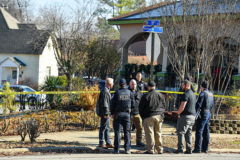 Investigators with the Fort Smith Police Department work, Friday, Feb. 3, 2023, at the site of a shooting death at a residence on the corner of Grand Avenue and 18th Street in Fort Smith. According to Aric Mitchell, FSPD public information officer, the homeowner, a 58-year-old male, contacted police around 9:45 a.m. to report the shooting of a 29-year-old knife-wielding man who allegedly broke into the residence. The suspected intruder died on scene from a gunshot wound to the abdomen. The homeowner was taken to a hospital at his request to treat non-life-threatening injuries. Visit nwaonline.com/photo for today's photo gallery.
(NWA Democrat-Gazette/Hank Layton)