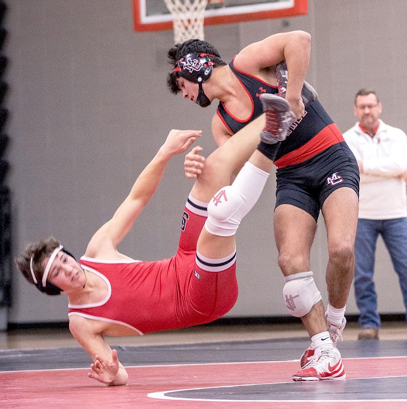Griffin Schutten/Special to McDonald County Press
McDonald County senior Blaine Ortiz (right) takes down Carl Junction's Kale Trospher during a senior night match held Feb. 2 at Mustang Arena.