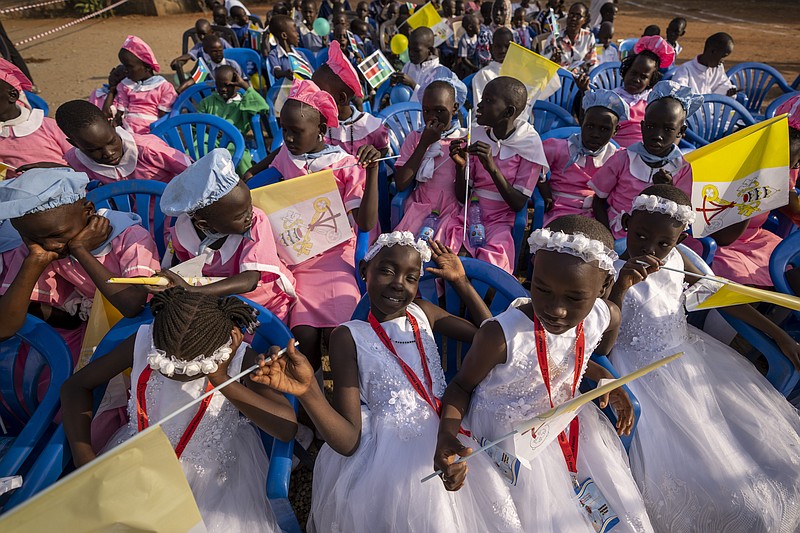 Young girls await the arrival of Pope Francis at the St. Theresa Cathedral in Juba, South Sudan, Saturday, Feb. 4, 2023. Pope Francis is in South Sudan on the second leg of a six-day trip that started in Congo, hoping to bring comfort and encouragement to two countries that have been riven by poverty, conflicts and what he calls a "colonialist mentality" that has exploited Africa for centuries. (AP Photo/Ben Curtis)