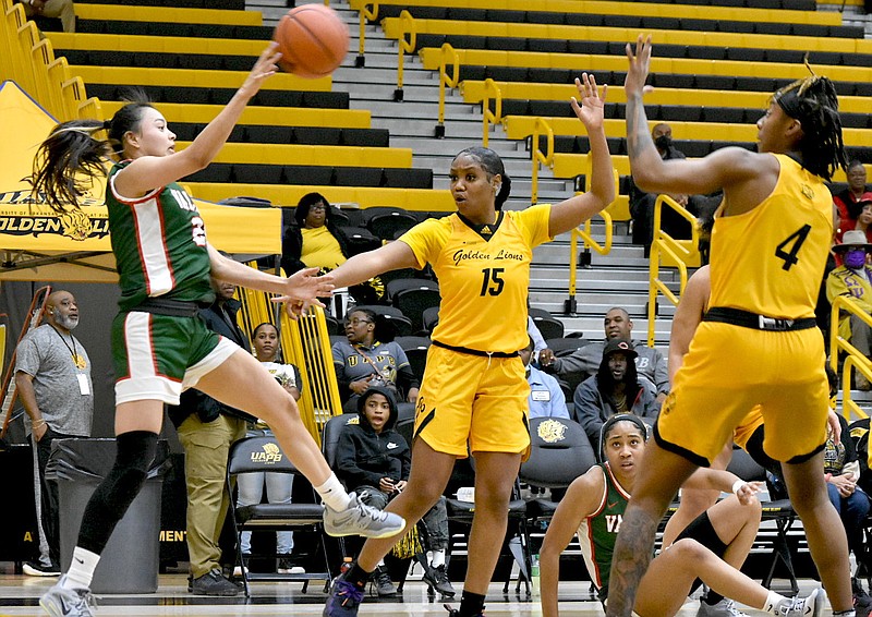 Coriah Beck (15) and Jelissa Reese (4) of UAPB force a pass in Jan. 28 home game against Mississippi Valley State. (Pine Bluff Commercial/I.C. Murrell)