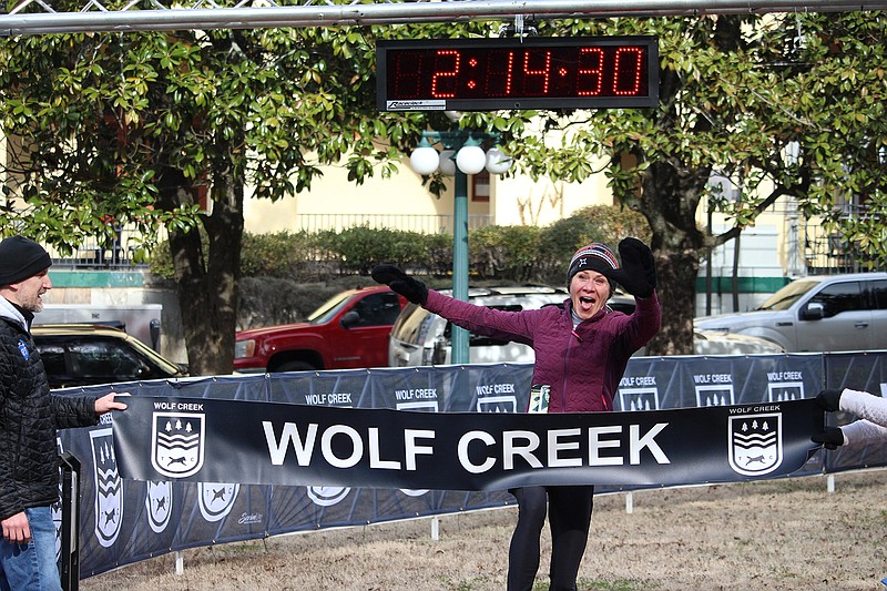 Blair Dean crosses the finish line as the first female finisher in the Hot Springs Half Marathon Saturday in front of The Arlington Resort Hotel & Spa. - Photo by Krishnan Collins of The Sentinel-Record