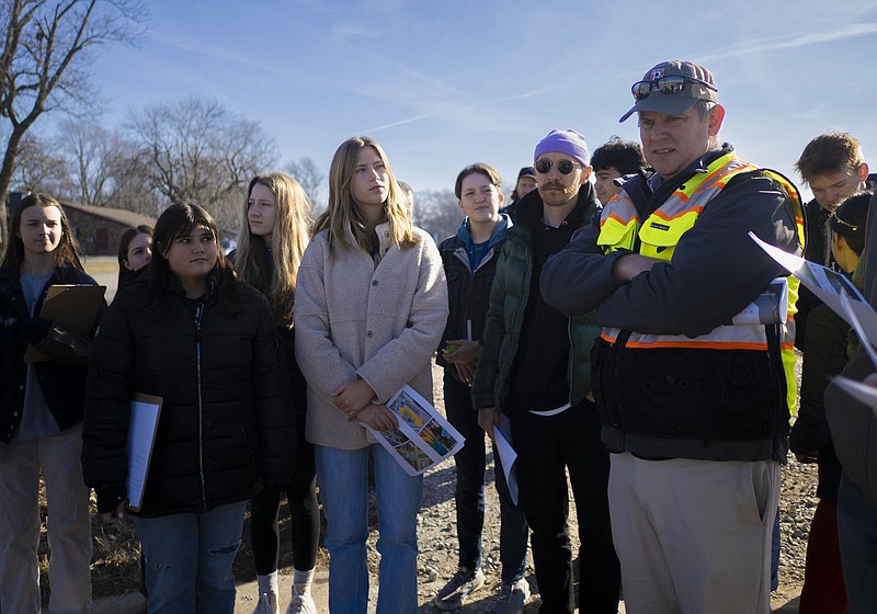 Thaden students discuss a street project plan with Dennis Birge, transportation director for the City of Bentonville (right), Monday, January 23, 2023 on the corner of SW 8th St. and S Main St. in Bentonville. Thaden School students met with the city Traffic Signage and Safety Committee to discuss a traffic calming project that the students have come up with. Visit nwaonline.com/photos for today's photo gallery.

(NWA Democrat-Gazette/Charlie Kaijo)