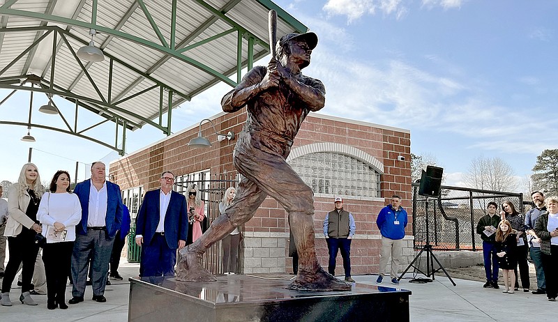 Dr. Robert Muldoon, right, and members of the family of the late Daniel B. Hamby look at the newly unveiled statue of Babe Ruth at the entrance to Majestic Park Monday. - Photo by James Leigh of The Sentinel-Record