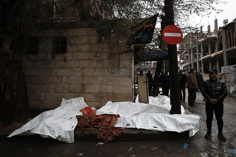 People try to identify the bodies of earthquake victims recovered outside a hospital, in Aleppo, Syria, Monday, Feb. 6, 2023. A powerful earthquake rocked wide swaths of Turkey and neighboring Syria on Monday, toppling hundreds of buildings and killing and injuring thousands of people. (AP Photo/Omar Sanadiki)