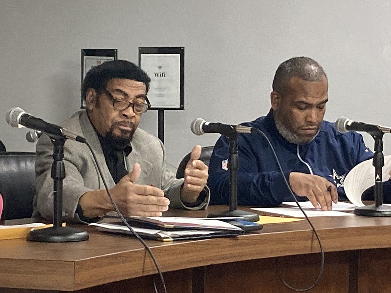 Council Member Glen Brown Sr. (left) and his son, Council Member Glen Brown Jr., look over a proposed resolution on Tuesday night during a special called meeting of the Pine Bluff City Council. (Pine Bluff Commercial/Byron Tate)