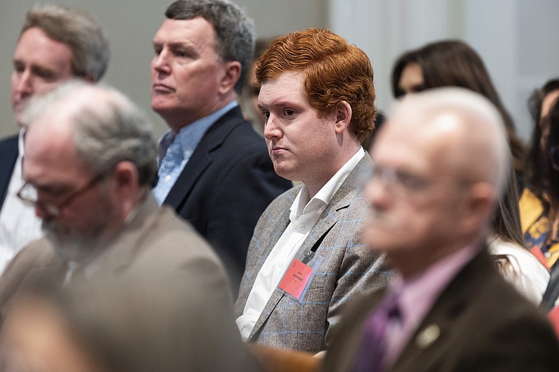 Buster Murdaugh, right, the son of Alex Murdaugh, listens to a