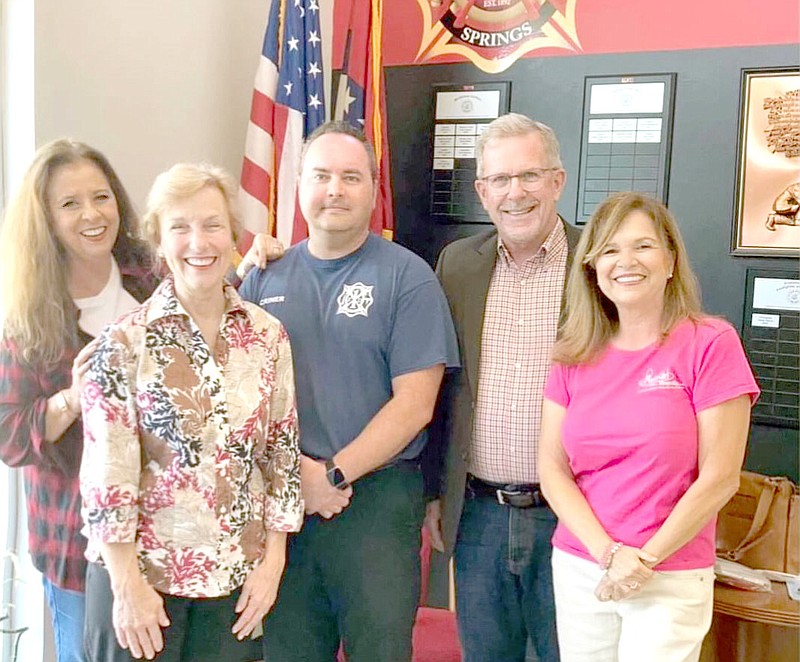 Photo submitted AudioGirl Lori Rae Martin (left), poses with State Representative Delia Haak (R-17); Fire Chief Jeremey Criner; New Life Church Pastor Tim Estes and fellow AudioGirl Sylvia Aimerito at Fire Station 1 in conjunction with the announcement of Siloam Springs' first Safe Haven Baby Box. The Safe Haven Baby Box allows mothers in crisis to leave their infants in a safe environment. The baby box alerts authorities that a baby has been placed inside and will move to safely secure the child.