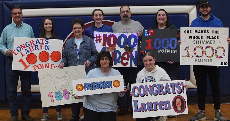 The Friedrich family celebrates Lauren Friedrich scoring her 1000th career point in California's win over Boonville on Thursday night. (Democrat photo/Evan Holmes)