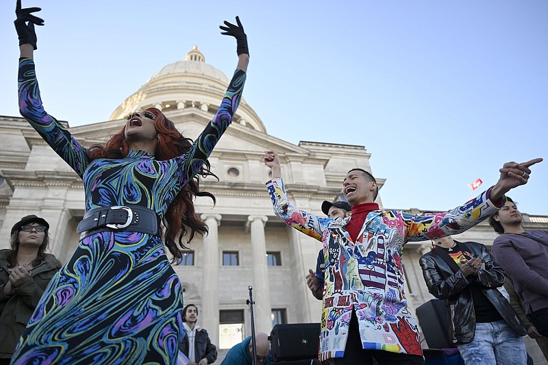 Athena Sinclair, left, sings on Jan. 19 on the steps of the Arkansas State Capitol during a protest against Senate Bill 43, which would classify drag performances as adult-oriented businesses.
(Arkansas Democrat-Gazette/Stephen Swofford)