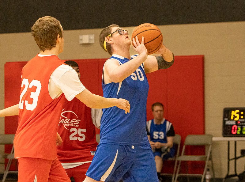 Josh Cobb/Jefferson City News Tribune photo: The Special Olympics  regional basketball tournament was held in Jefferson City on Saturday, Feb. 18, 2023. Noah Adams of the Sedalia Storm (50) goes for the shot as Riley Fitzgibbons (23) and Amir Ksaibat (25) of the Wentzville Eagles watch.