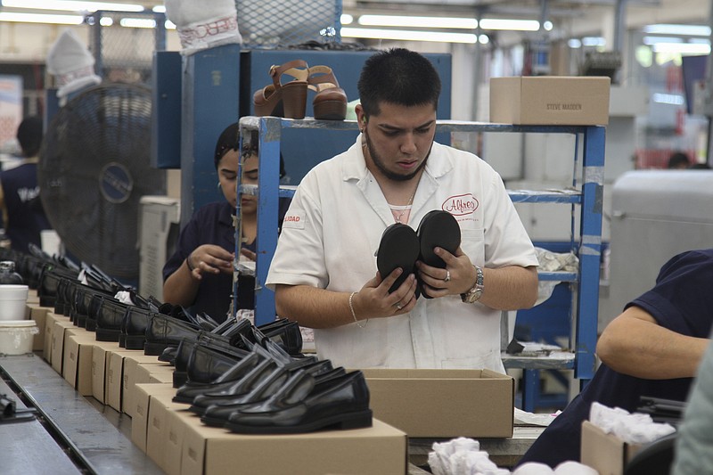 People work in a shoe maquiladora or factory in Leon, Mexico, Monday, Feb. 7, 2023. t has been nearly two years since the United States began pressing Mexico over labor rights violations, by using rapid dispute resolution methods (RRM) contained in the U.S.-Mexico Canada free trade agreement.  (AP Photo/Mario Armas)