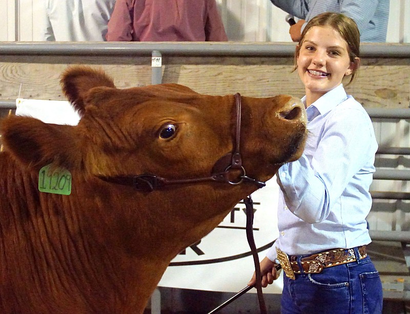 Brooklyn Carte, Gravette FFA/Logan 4-H, shows her animal at the Benton County Fair junior livestock auction.