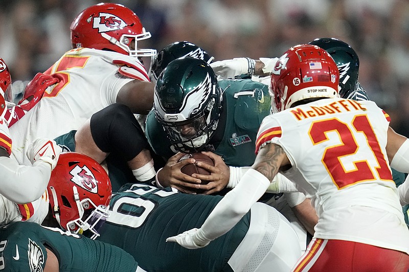 Philadelphia Eagles quarterback Jalen Hurts (1) pushes for the first down against the Kansas City Chiefs during the second half of the NFL Super Bowl 57 football game, Sunday, Feb. 12, 2023, in Glendale, Ariz. (AP Photo/Ashley Landis)