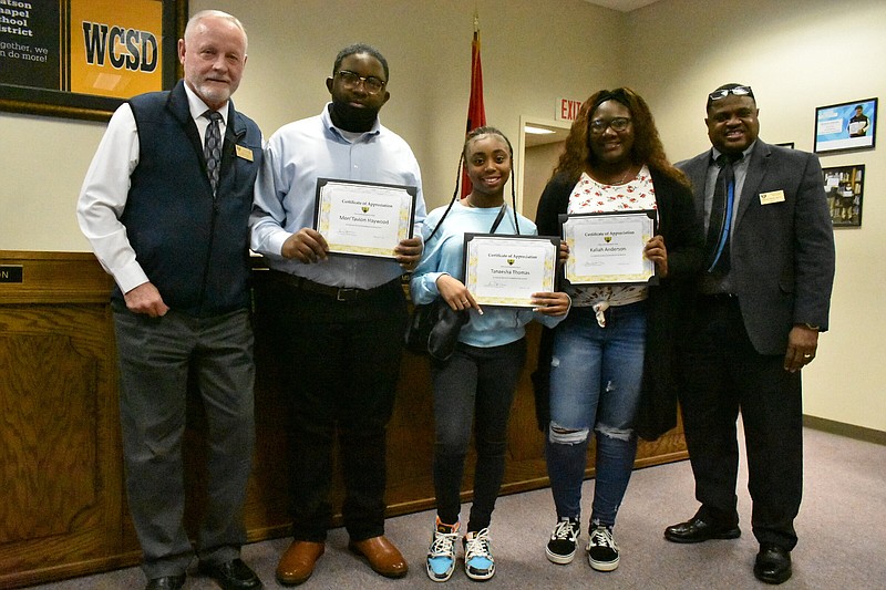 From left, Watson Chapel School District Superintendent Tom Wilson congratulates Mon'Tavion Haywood, Tanaesha Thomas and Kaliah Thomas on being named Wildcat Warriors for February. Also pictured is high school Principal Henry Webb. (Pine Bluff Commercial/I.C. Murrell)