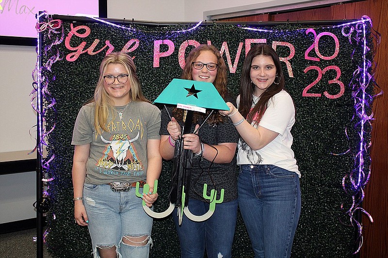 Photo by Michael Hanich.
From left, Della Ables, Claire Beaver and Jaycee Sanders hold up the lamp that won them 1st place in the CNC cutting competition at Girl Power to the Max.