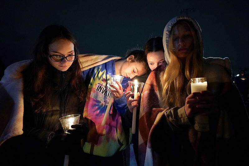 Mourners attend a candlelight vigil for Alexandria Verner at the Clawson High School football field in Clawson, Mich., Tuesday, Feb. 14, 2023. Verner was among the students killed after a gunman opened fire on the campus of Michigan State University Monday night.  (AP Photo/Paul Sancya)