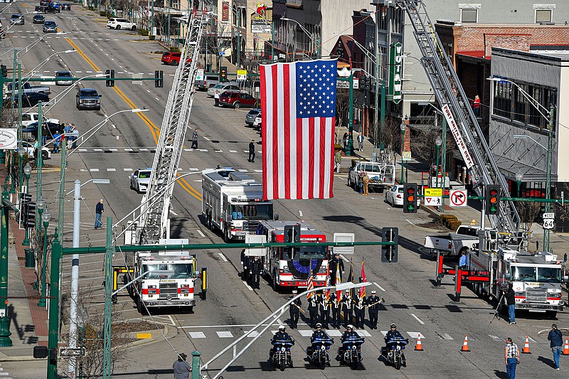 The funeral procession for Fort Smith Fire Chief Phil Christensen travels Wednesday along Garrison Avenue in downtown Fort Smith. The procession for Christensen, who died this past Saturday after a nine-month battle with cancer, started at Fire Station No. 1 and ended at Evangel Temple for his funeral service. Visit nwaonline.com/photo for today’s photo gallery.

(NWA Democrat-Gazette/Hank Layton)