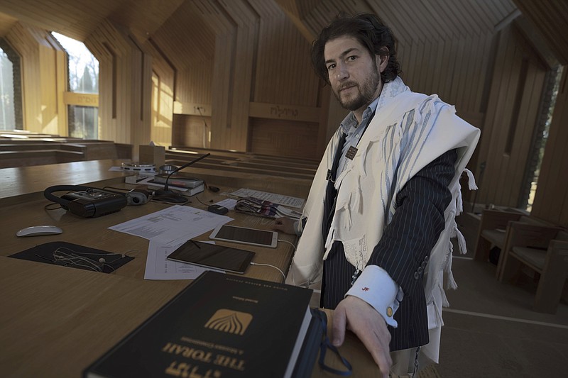 Rabbi Joshua Franklin stands inside the sanctuary at the Jewish Center of the Hamptons in East Hampton, New York on Feb. 10, 2023. Franklin expermented writing a sermon for his congregation using artificial intelligence software Chat GPT, and concluded that AI can't replace the work of human faith leaders. (AP Photo/Robert Bumsted)