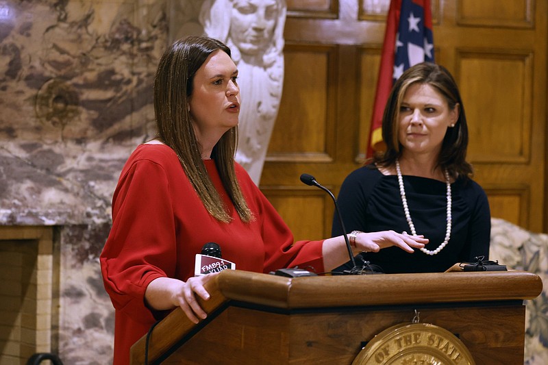 Gov. Sarah Huckabee Sanders (left) and Kristi Putnam (right), Secretary of the Arkansas Department of Human Services, announce the state would seek federal approval  to require ARHOME participants to work, volunteer or enroll in classes, on Wednesday, Feb. 15, at the state Capitol in Little Rock. (Arkansas Democrat-Gazette/Thomas Metthe)