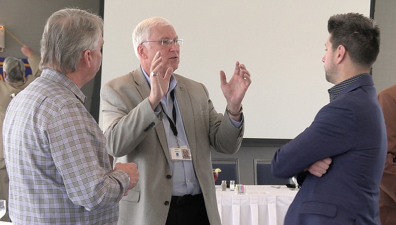 Steve Arrison, center, visits with members of the Rotary Club of Hot Springs National Park following his presentation.– Photo by Courtney Edwards of The Sentinel-Record