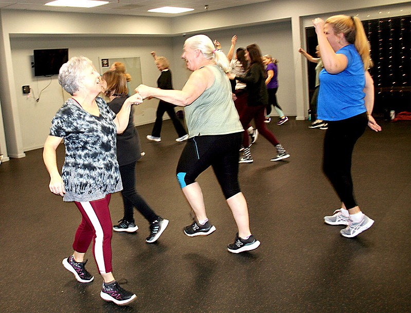 Zumba teacher Dina Lombardo (left) aims to make her classes fun with a variety of music and custom choreography.

(Special to NWA Democrat-Gazette/Lynn Atkins)