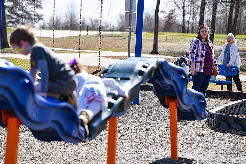 Lindsey Jones (center) and her mother Nancy Asbury (right), both of Fort Smith, watch Jones’s children Nathan Jones, 6, and Ashlynn Jones, 4, play, Wednesday, Feb. 15, 2023, at Barling City Park in Barling. The Barling Board of Directors will discuss a resolution authorizing the mayor to enter into an architectural contract for a project to build a walking trail and pavilion at Mercy Crest, a retirement home in Barling. Visit nwaonline.com/photo for today's photo gallery.
(River Valley Democrat-Gazette/Hank Layton)