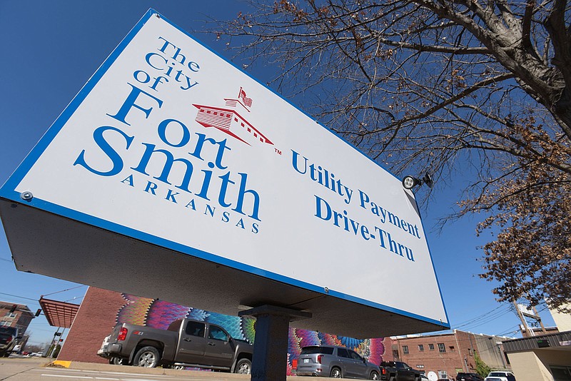 A sign for the City of Fort Smith Utility Department payments drive-thru is seen on Friday, Feb. 18, 2022, in downtown Fort Smith. (NWA Democrat-Gazette/Hank Layton)